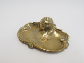 A Victorian brass inkwell with pen tray