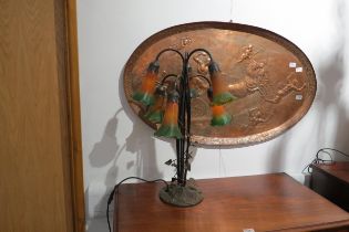 A six arm table lamp of Art Nouveau style with yellow and green fluted shades, creeping vine to stem