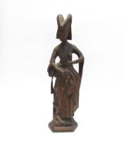 A 19th Century oak carved sculpture of a Pleurant / weeper, 61cm high