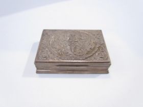 A Thai silver cigarette box, repousse lid with central deity surrounded by scrolled foliage,