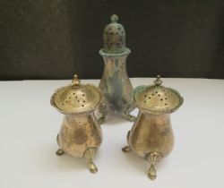 A pair of silver pepperettes, Chester 1918 and a taller pepperette, London 1926, 244g