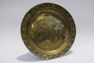 An 18th Century embossed brass Adam & Eve biblical charger/Alms dish, 30cm diameter