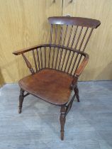 A circa 1860 elm and ash "Thames Valley" raised stick back armchair on turned legs united by an "