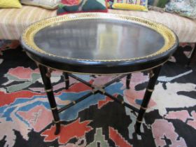 A Regency papier mache black lacquered oval Gentleman's tray table with gilt border. The tray