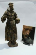 A 17th Century Spanish polychrome sculpture of Francis of Assisi in a time worn state with