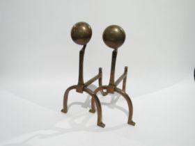 A pair of Arts and Crafts copper fire dogs