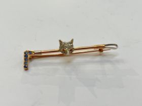 A stock pin with a diamond encrusted fox head on a riding whip with sapphire studded handle, 4.4g