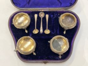 Four Martin Hall and Co silver salts in fitted case with three silver salt spoons, London 1874, 126g