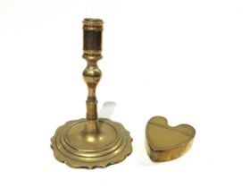 A Georgian brass candlestick and Georgian brass heart form snuff box, 16.5cm tall and 8.3cm long (2)