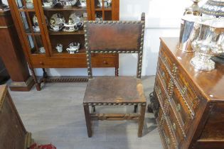 A late 17th/early 18th Century Spanish walnut chair with leather back and seat (repairs and distress