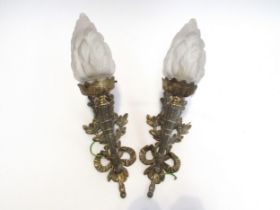 A pair of ormolu wall brackets in classical torch style, with frosted glass flame shades
