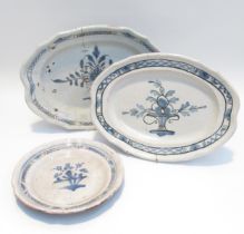 Three 19th Century French Faience serving plates with black bottoms all with cracks and chips, two