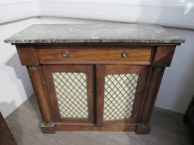 A late 19th Century marble top sideboard with single drawer above lattice panel doors, column detail