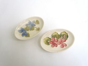 Two Moorcroft oval pin dishes, blue and pink Campanula, one chipped