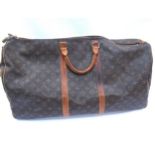 LOUIS VUITTON; Keepall 60 Boston travel bag. Brown monogram. The leather handles, banding and piping