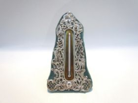 A William Comyns silver easel-back table thermometer, pierced design of the four seasons and sun,