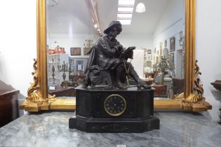 A 19th Century large state mantel clock, aloft a seated gent wearing period costume and hat