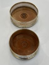 Two silver wine coasters one plain, one pierced, both with treen bases, M.C. Hersey & Son Ltd.,