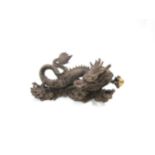 A Chinese bronze five clawed dragon. 23cm length