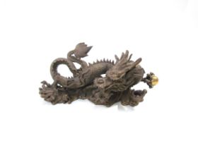 A Chinese bronze five clawed dragon. 23cm length