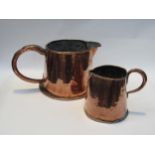 Two 19th Century copper jugs of barrel for, 15.5 cm and 18.5cm tall