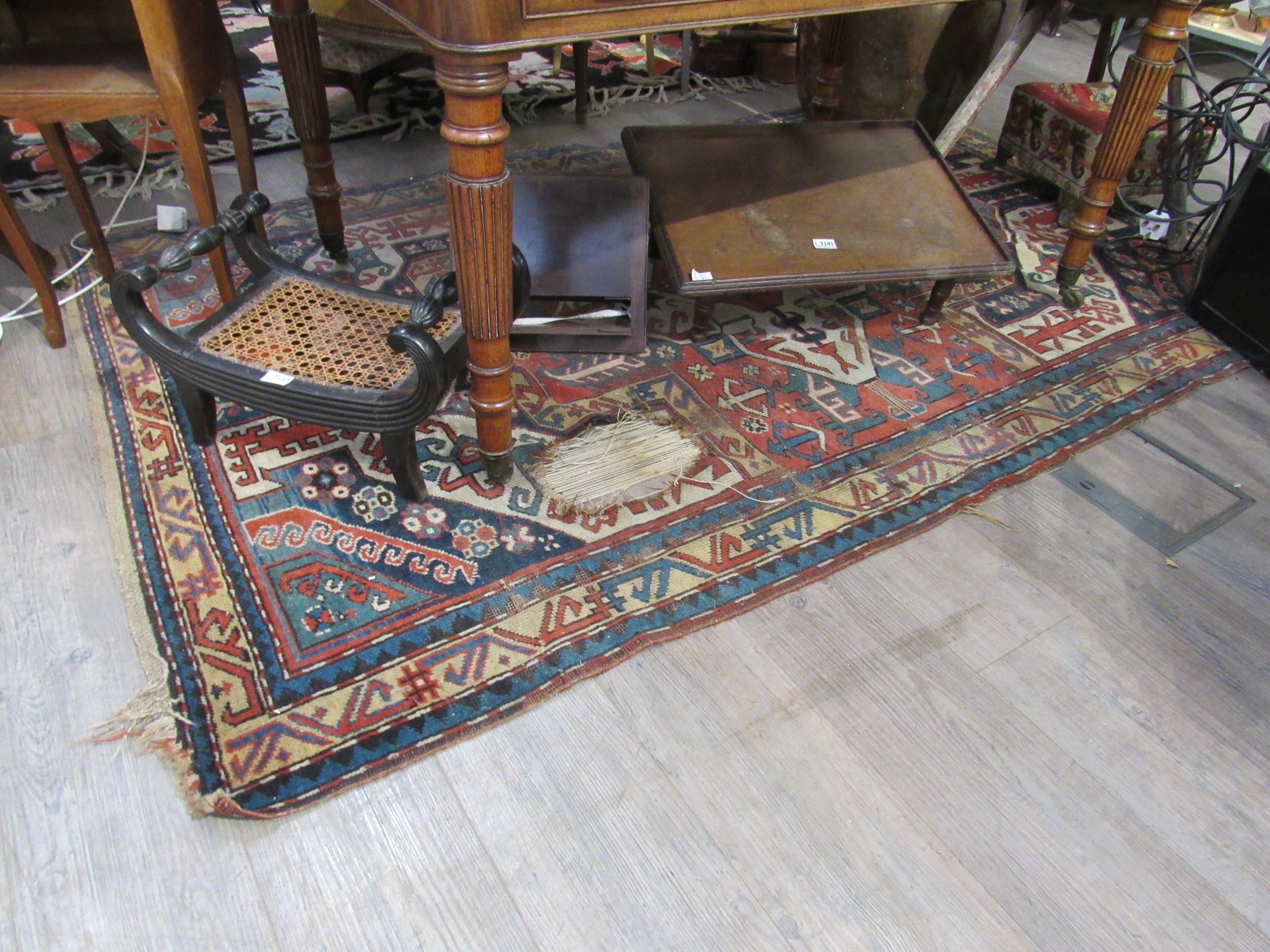 An early 20th Century hand woven Persian rug, badly worn, 230cm x 144cm