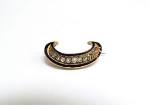 A Victorian "C" shaped brooch, gold set with rose cut diamonds on a blue enamelled ground, 2.7cm