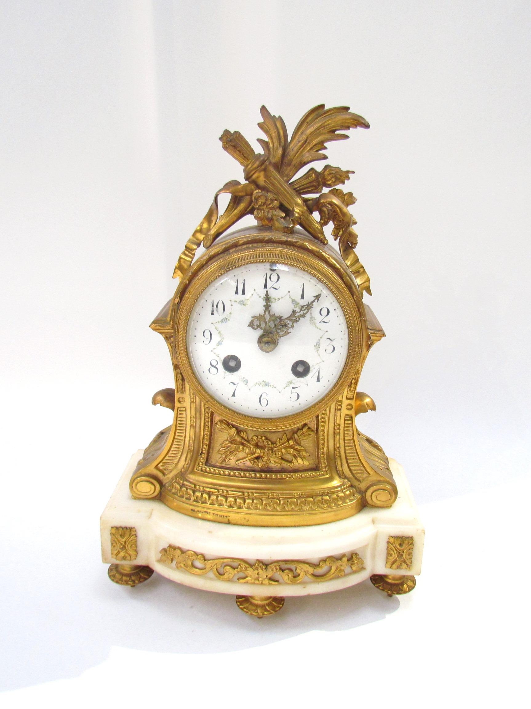An early 19th Century French Ormolu mantel clock with white enamel dial, Arabic numerals with two