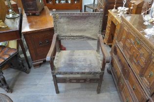 A late 17th/early 18th Century Spanish walnut armchair with embossed leather back and seat (distress