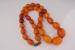 An amber beaded necklace, 70cm long, 104g