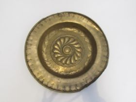 A 17th Century brass alms dish, some damage present, 39.5cm diameter