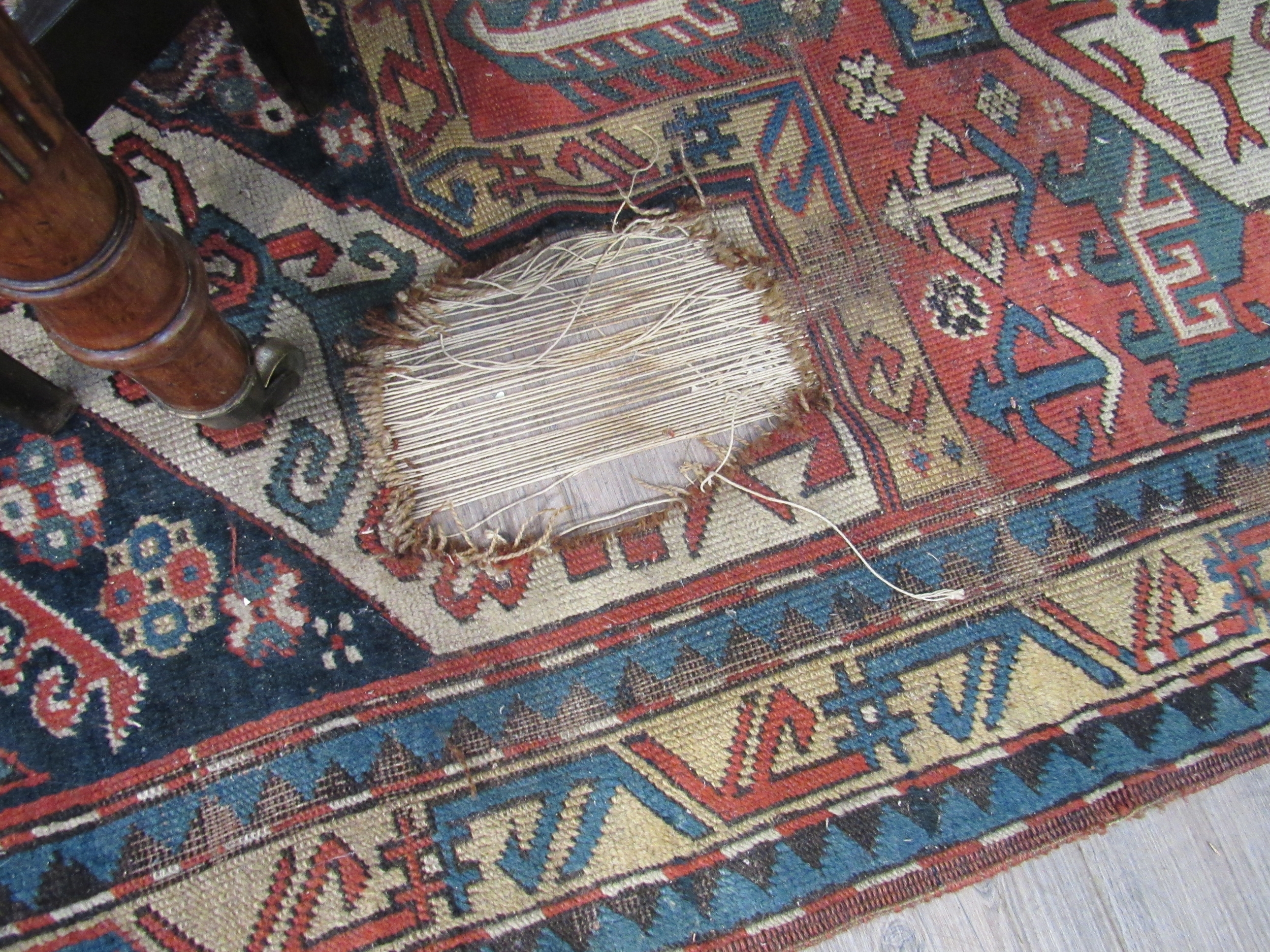 An early 20th Century hand woven Persian rug, badly worn, 230cm x 144cm - Image 2 of 2