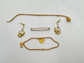 A 9ct gold bar brooch, pair of unmarked gold peacock drop earrings, charm bracelet and bracelet hung