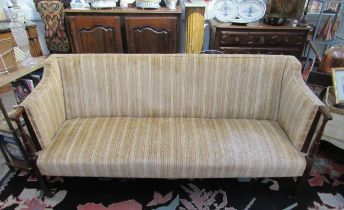 A late 19th Century square back sofa with turned arms to reeded tapering square legs to castors,