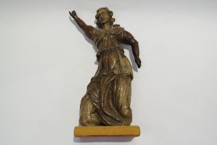 A 17th Century carved fruit wood female figure with hand aloft, elements maybe missing from back,