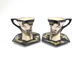 A pair of Moorcroft Au Lait pattern coffee cups and saucers