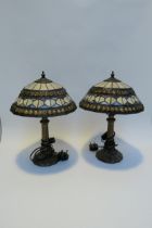 A pair of Tiffany style leaded stained glass table lamps, Art Nouveau style bronzed bases, 42cm tall
