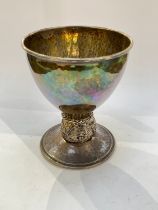 A Ramsden and Carr (Omar Ramsden and Alwyn Carr) silver goblet, hammered finish with lion mask