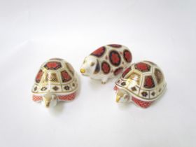 A pair of Royal Crown Derby paperweights as Tortoises, gold stoppers and a Royal Crown Derby