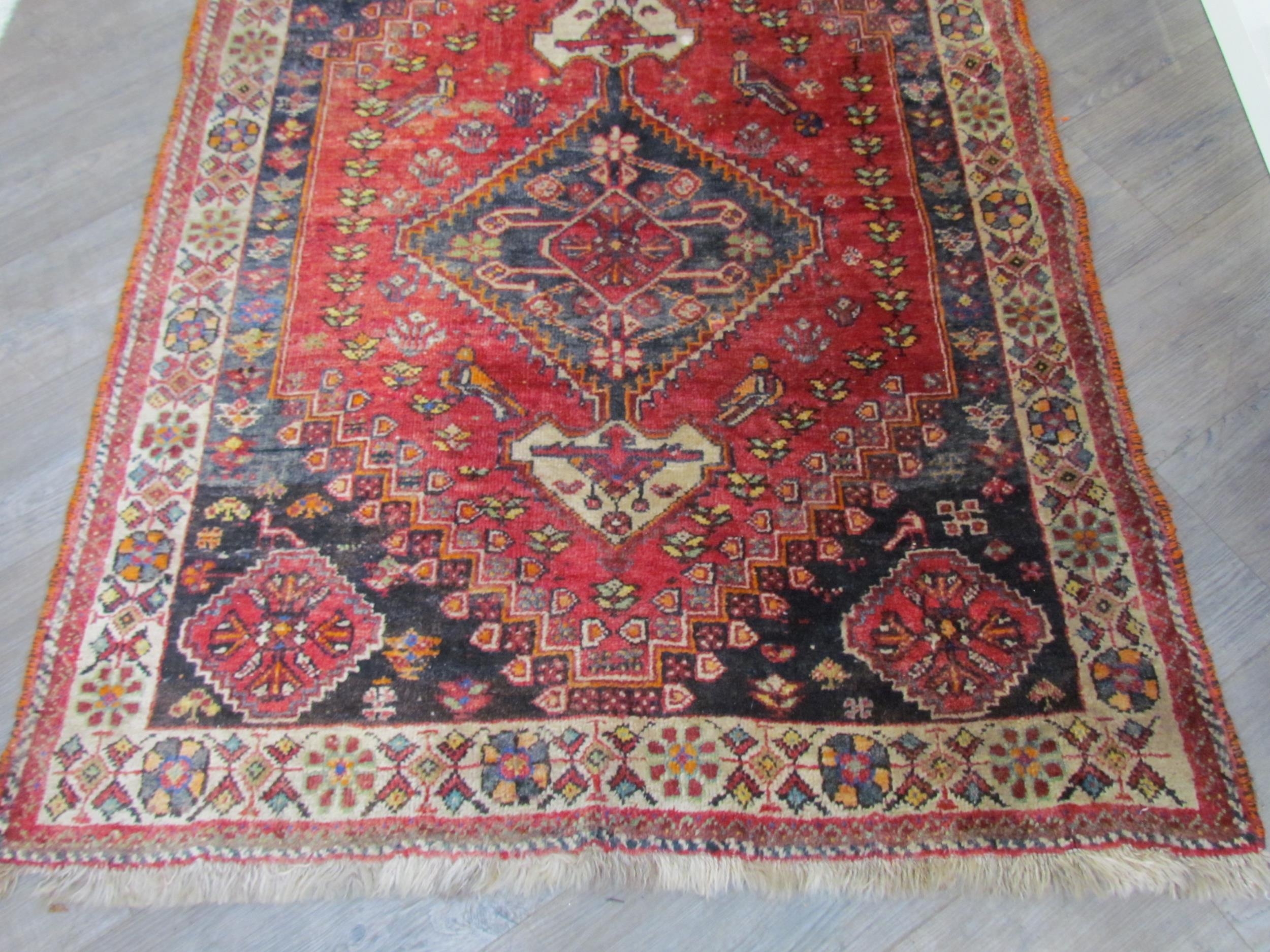 A Persian hand knotted wool rug, red ground with birds and floral borders, 155cm x 115cm - Image 2 of 7
