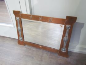 An Arts and Crafts copper wall mirror, the top rail with 'E.G.H.' lettering, the sides with inset