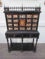 An 18th Century European cabinet on stand, the spindle rail cornice over an eight drawer and