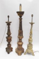 Three 19th Century carved wood lamp bases in a rustic condition, 94cm, 76cm and 73cm tall