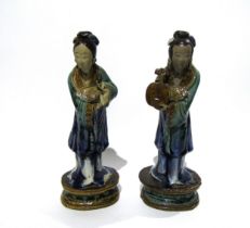A pair of late 19th Century / early 20th Century glazed Shiwan pottery figures both with areas of