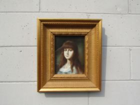 An unsigned oil on board portrait of a young woman with red hair, set in an ornate gilt frame and