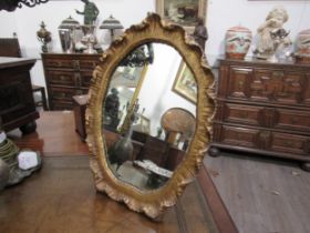 A gilt gesso free-standing table top mirror, 45cm x 35cm