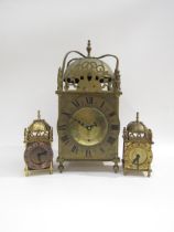 A large brass modern lantern clock with quartz movement and two smaller examples (3)