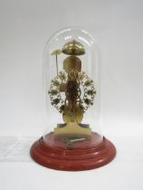A brass kieninger skeleton clock, movement stamped AJK, under glass dome. Pierced dial with Roman