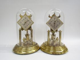 A near identical pair of brass anniversary clocks under glass dome, one marked Koma to back. Both