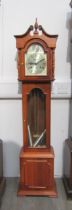 A reproduction 31 day Grandmother clock with pendulum and two weights, 143 cm tall
